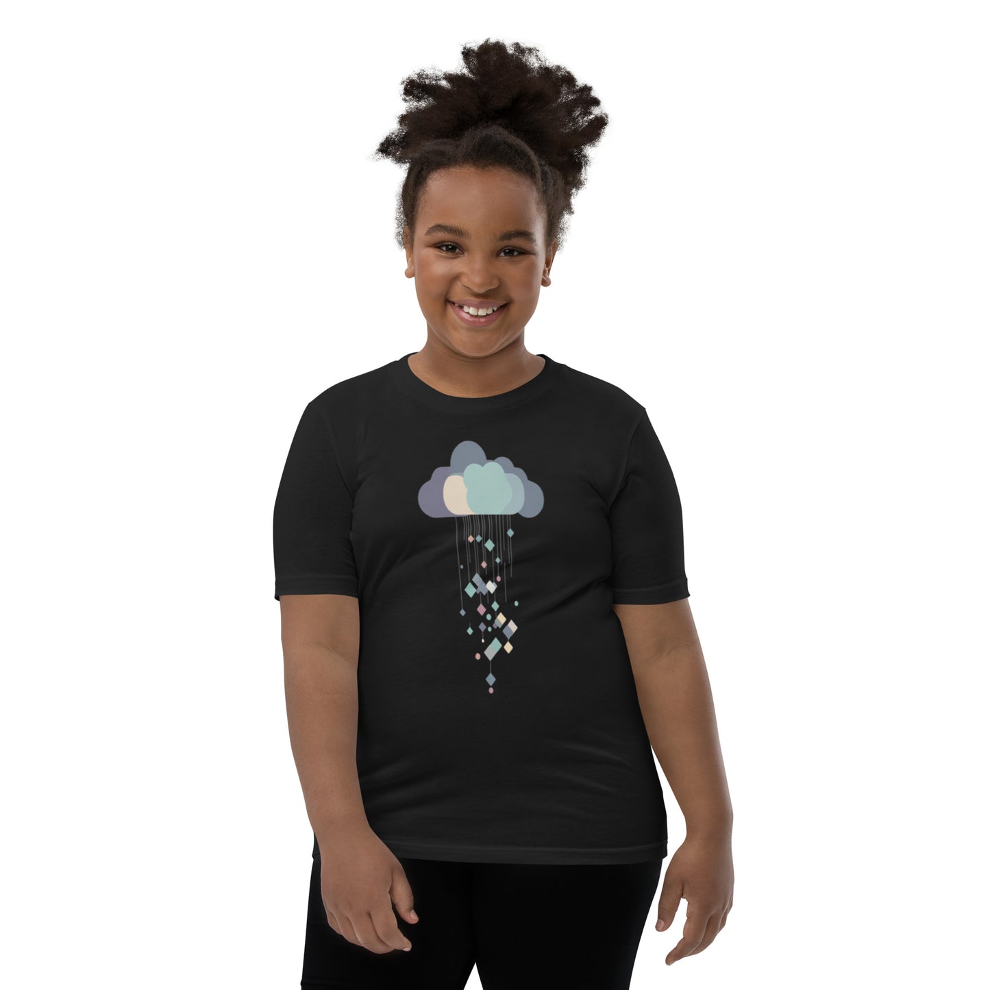 Smiling child wearing a black youth t-shirt with a cloud and geometric rain design in pastel colors.