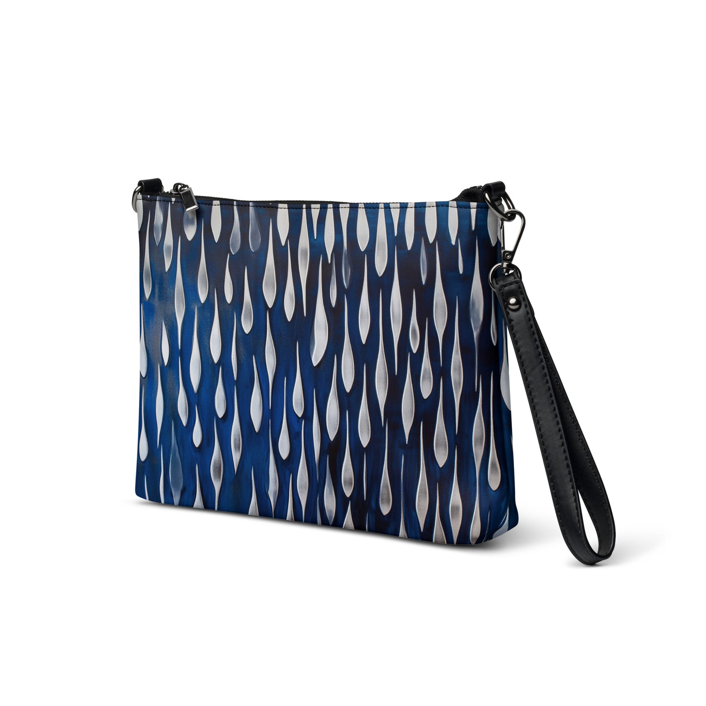 Angled view of a blue crossbody bag showcasing its teardrop pattern and black wrist strap.