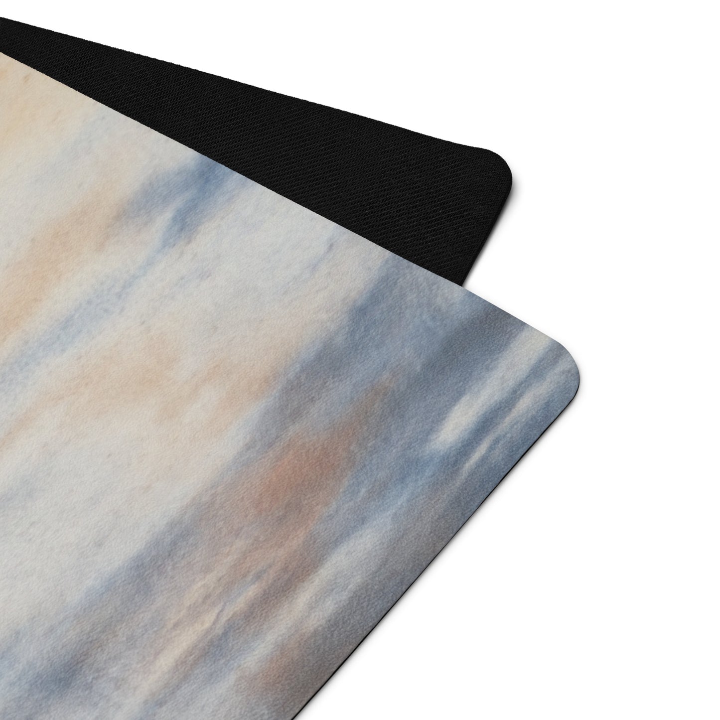 Close-up of a yoga mat’s edges, showing its watercolor-inspired pattern and black non-slip backing for stability and comfort during workouts