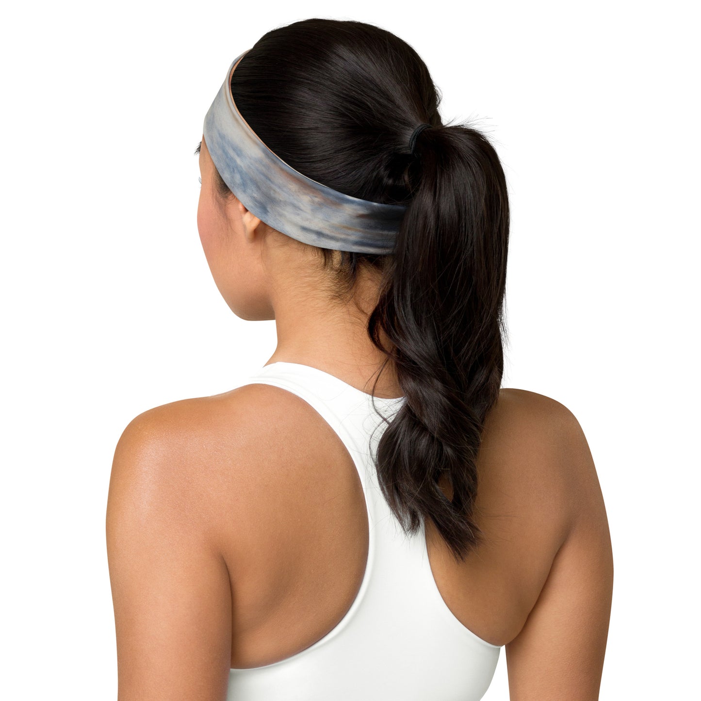 Earthy tones tie-dye headband in beige and blue, worn by a woman with a ponytail, showcasing its back design and seamless fit