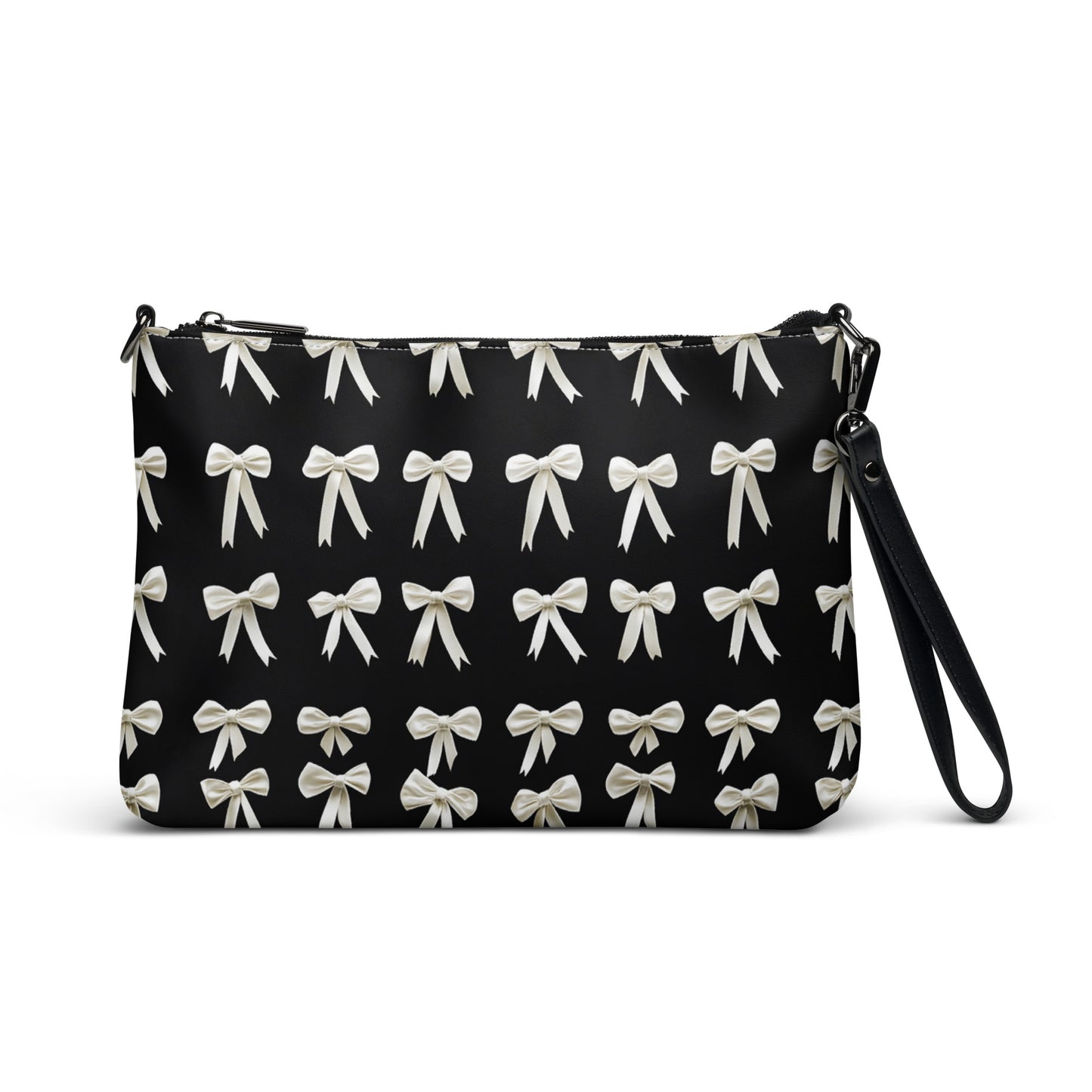 The back view of a crossbody bag adorned with an elegant pattern of white bows against a sleek black background, offering a sophisticated touch.