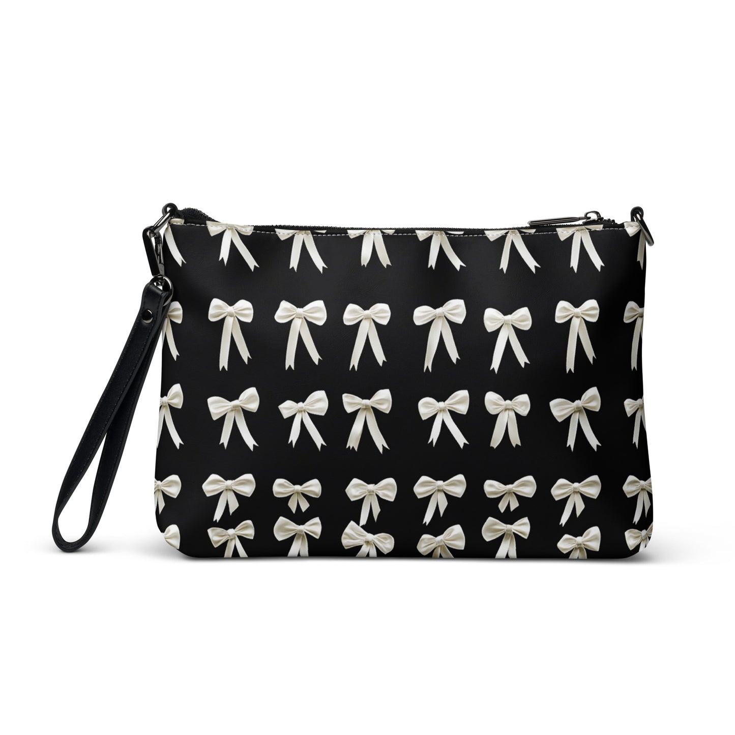 The back view of a crossbody bag adorned with an elegant pattern of white bows against a sleek black background, offering a sophisticated touch.