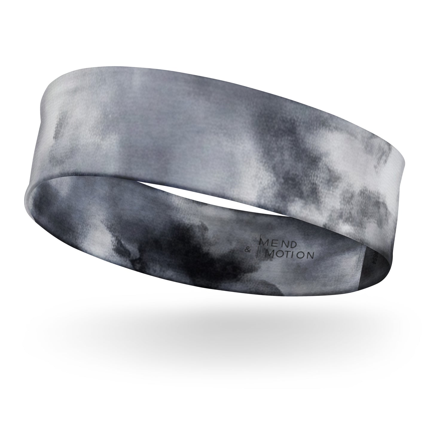 Gray and white tie-dye headband floating on a white background, highlighting its soft texture and modern pattern