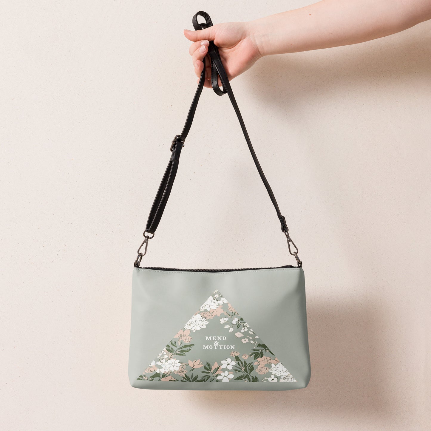 Soft green hues and a delicate floral triangle design make this bag a versatile and elegant accessory for every occasion