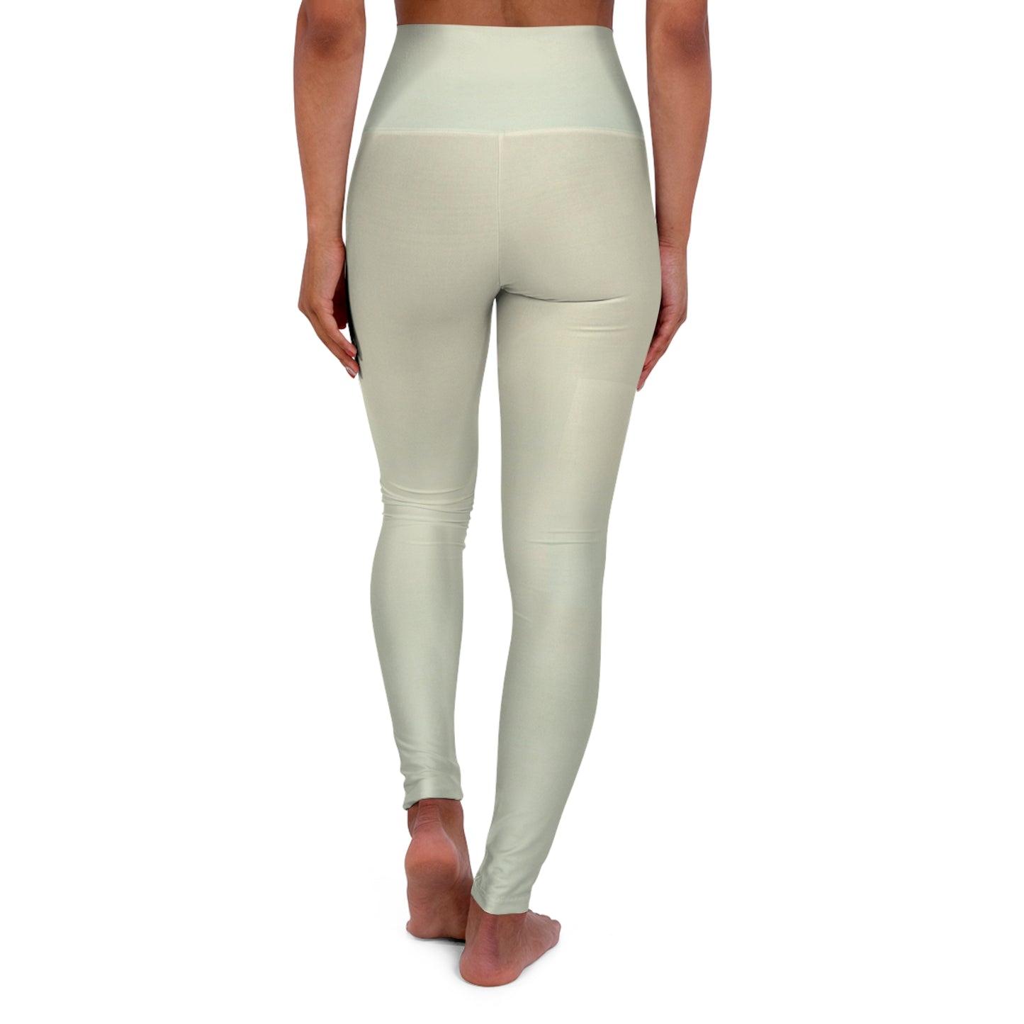 Back view of high-waisted leggings in light green, highlighting the seamless waistband and simple design.