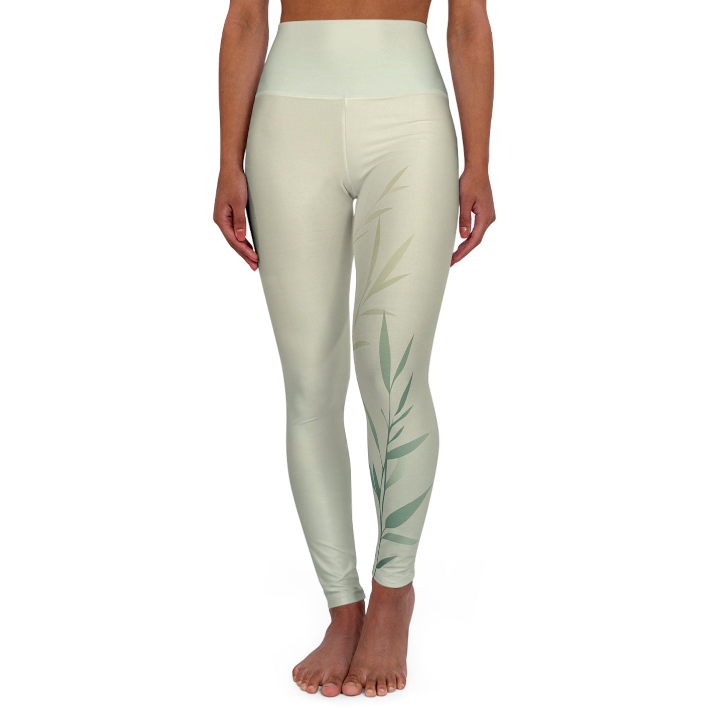 Front view of high-waisted leggings in light green with a minimalist leaf design on the right leg.