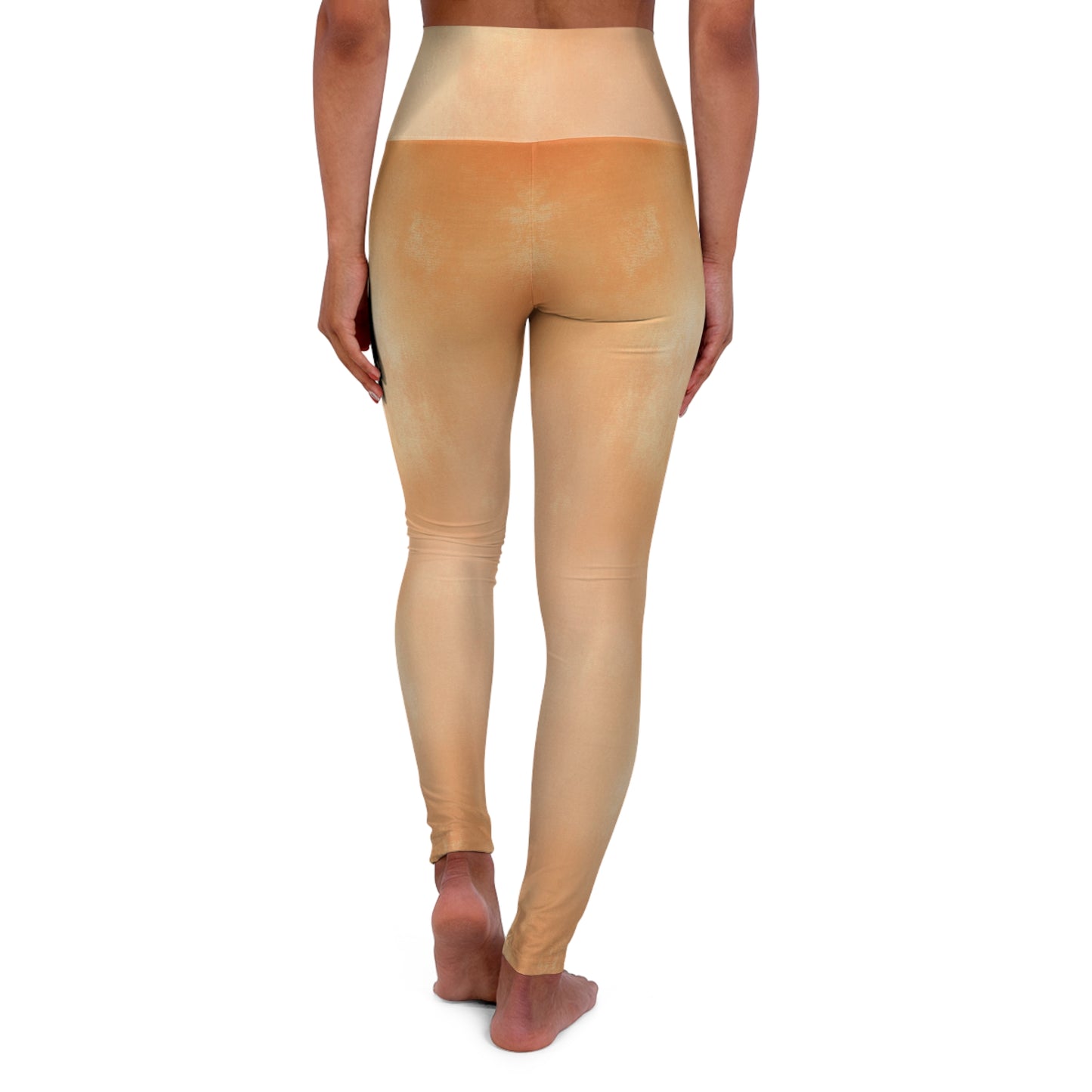 Back view of light gold high-waisted leggings, demonstrating their seamless construction and smooth texture.