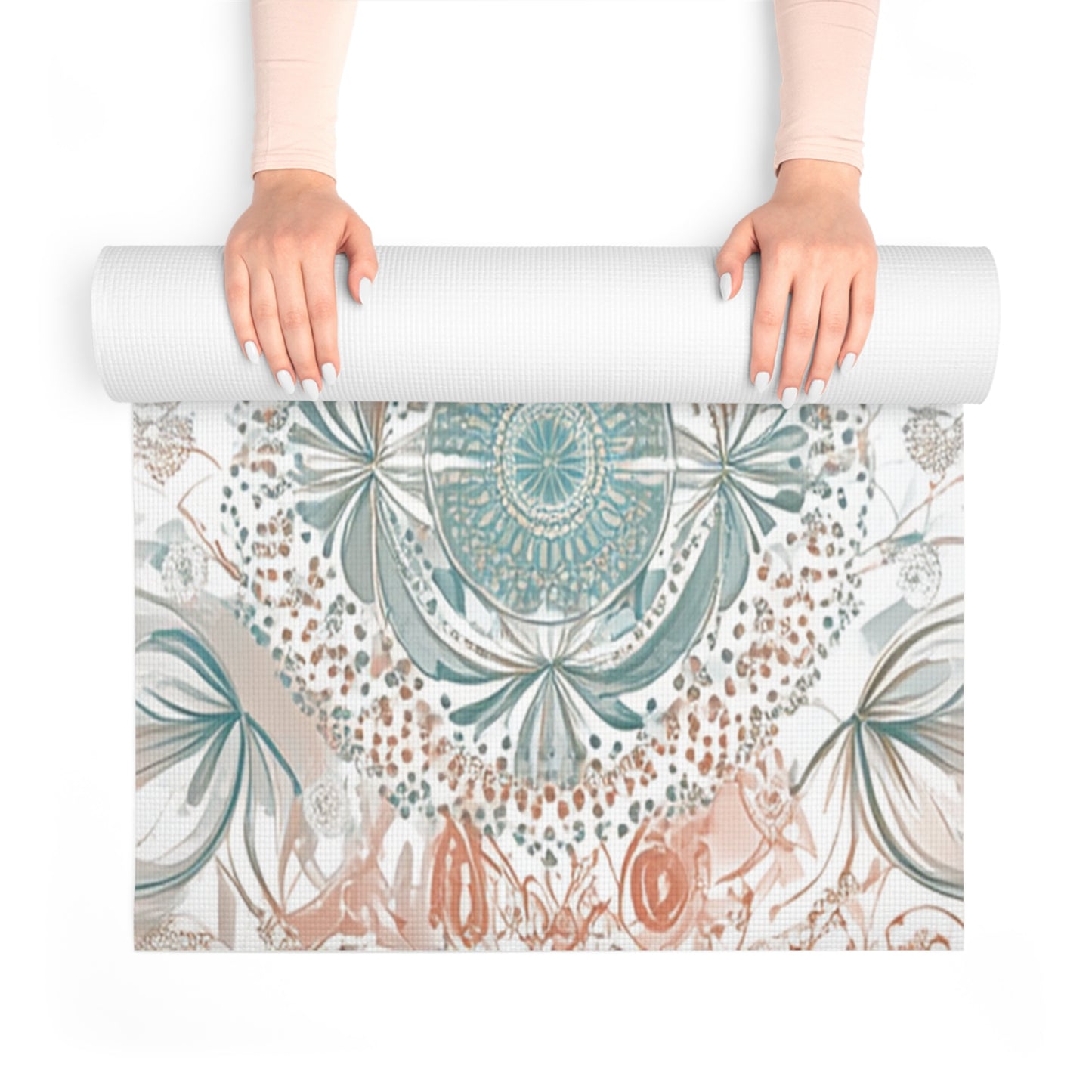 Hands rolling up a yoga mat with a mandala design in teal and beige
