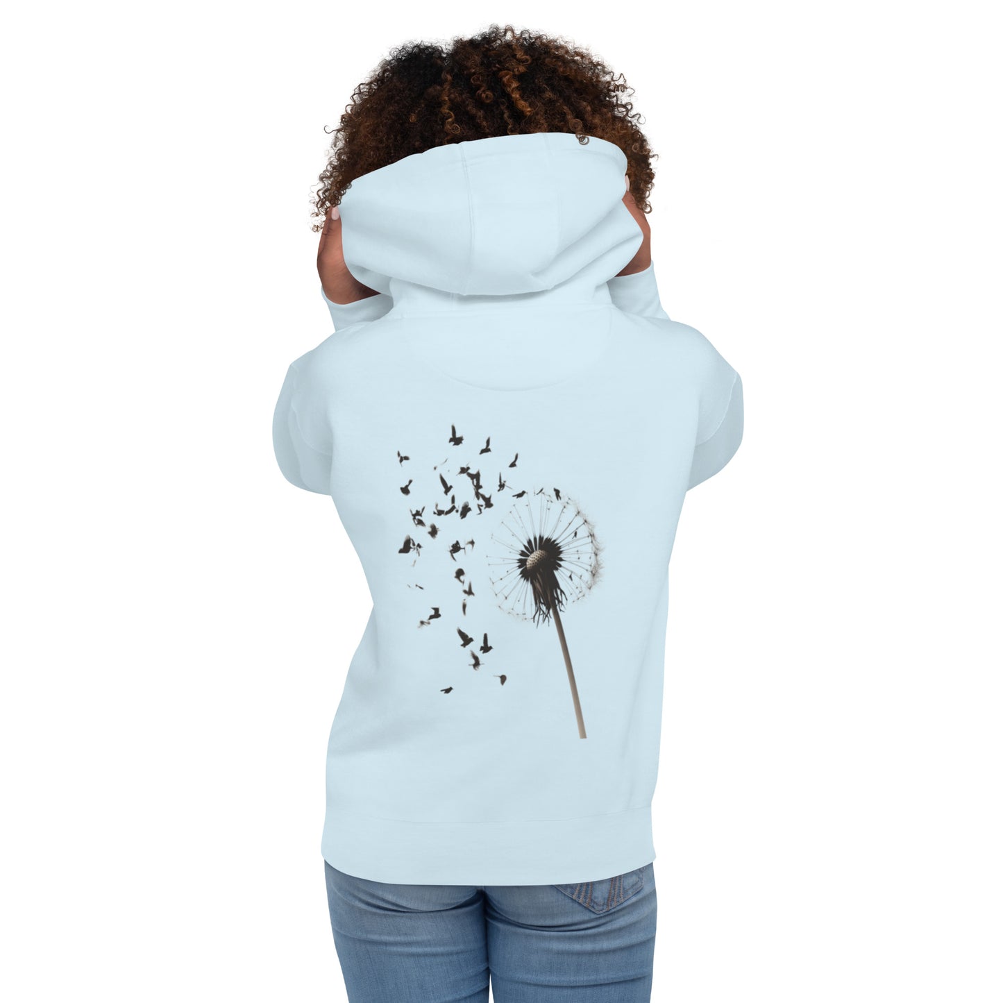 Model in sky blue hoodie with a dandelion dispersing into birds design on the back.