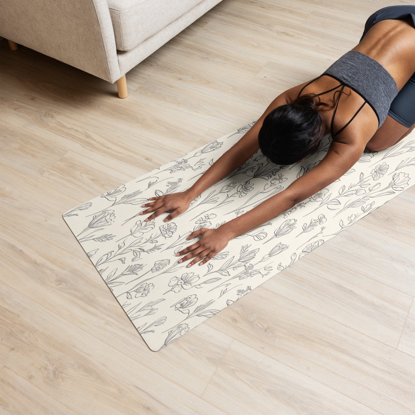 Beige yoga mat with a delicate floral sketch pattern featuring tulips and other wildflowers, laid flat to showcase the full design