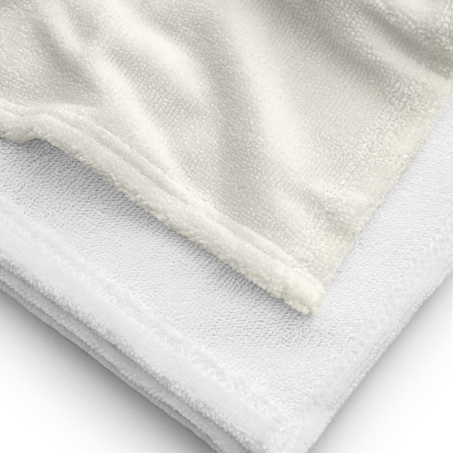 Close-up of soft white towel fabric highlighting texture and stitching