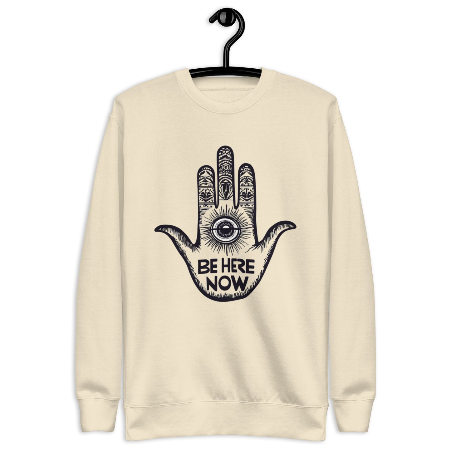 Bone-colored sweatshirt adorned with a detailed hand illustration and the phrase 'Be Here Now'