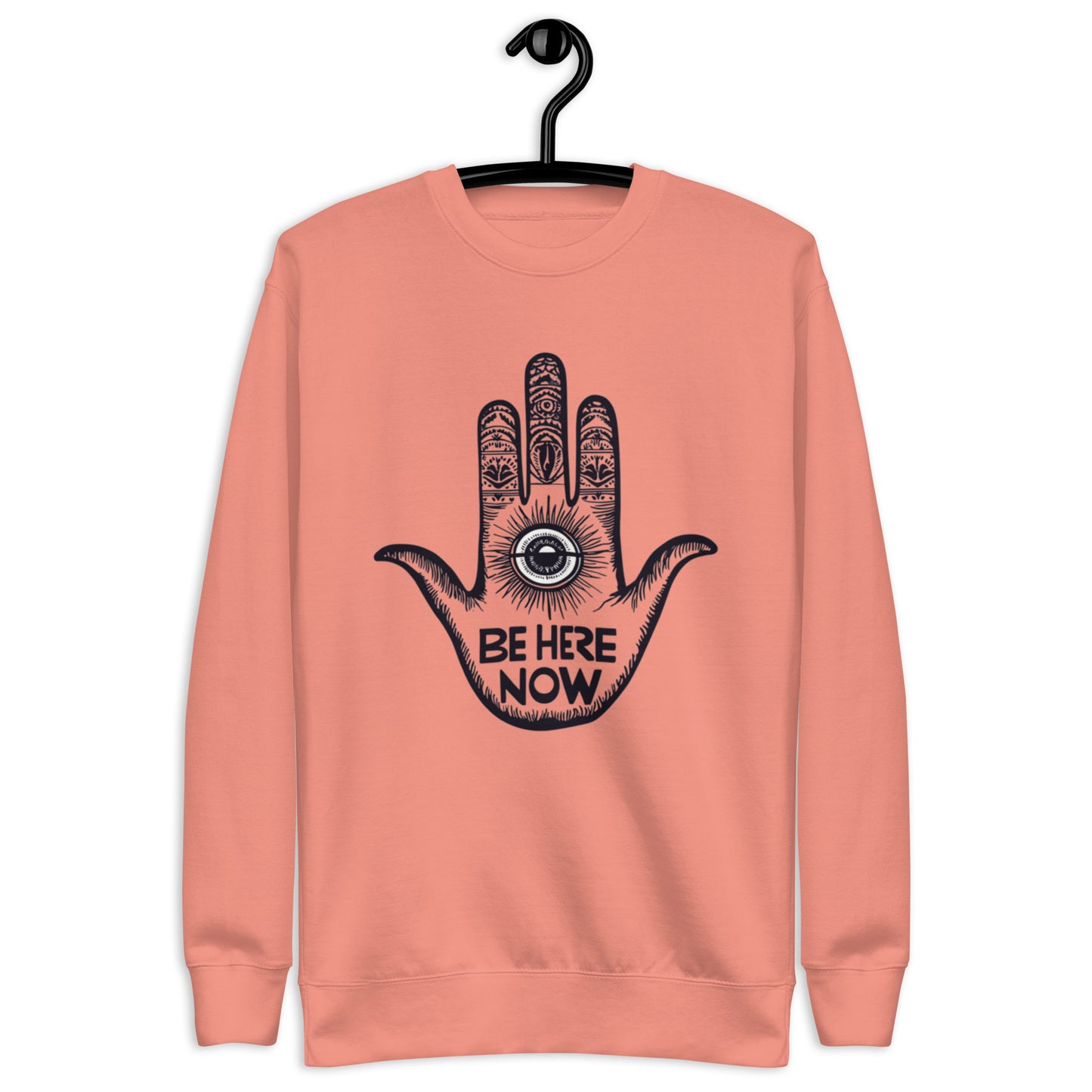 Dusty rose sweatshirt showcasing a hand design with intricate details and the motivational phrase 'Be Here Now'