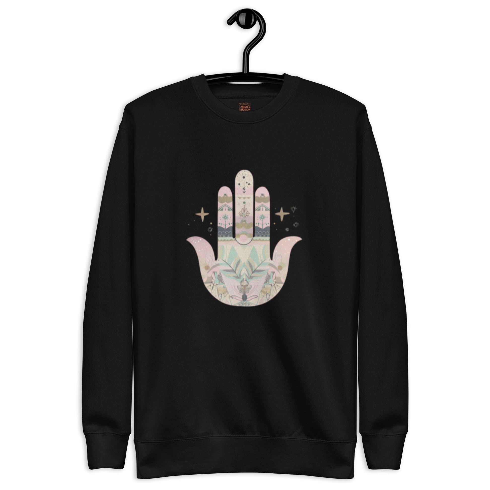 A black sweatshirt featuring a pastel-colored Hamsa hand design with floral and geometric elements, displayed on a hanger.