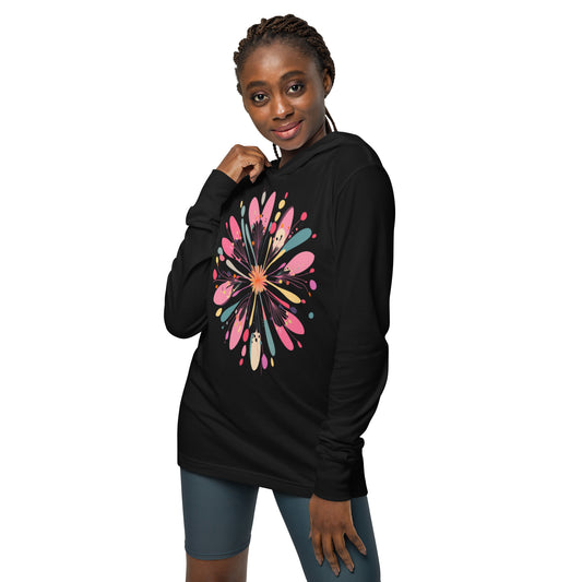 Model wearing black hoodie with colorful abstract flower design.