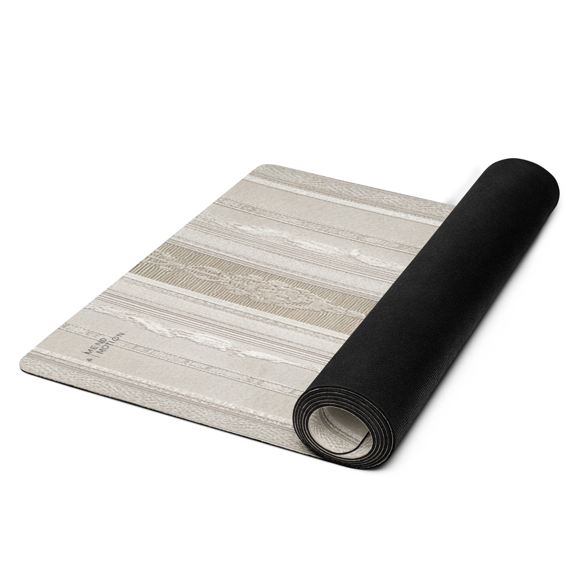  Beige yoga mat with floral designs, partially rolled up to display the black underside and pattern.