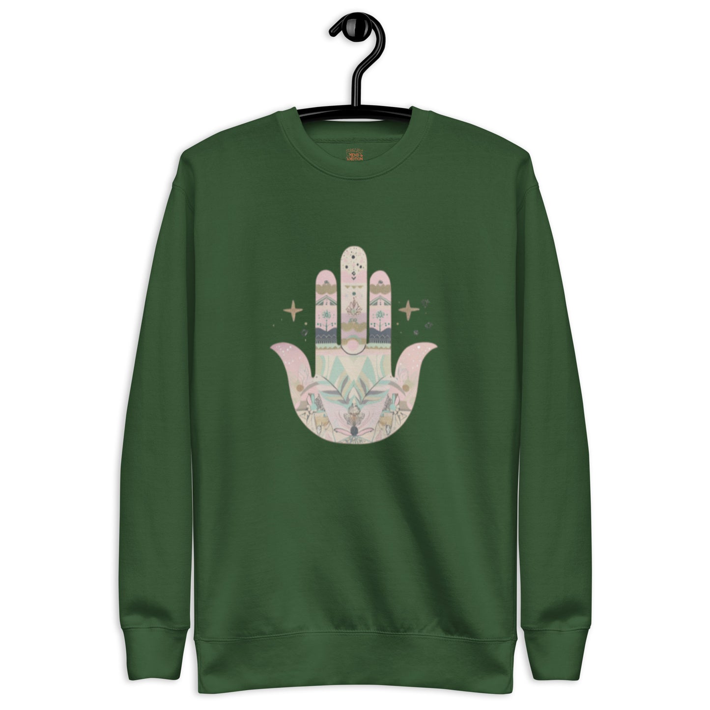 A deep forest green sweatshirt featuring a pastel-colored Hamsa hand design with floral and geometric elements, displayed on a hanger.