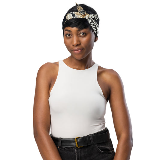 Woman wearing a golden mandala patterned bandana tied as a headpiece