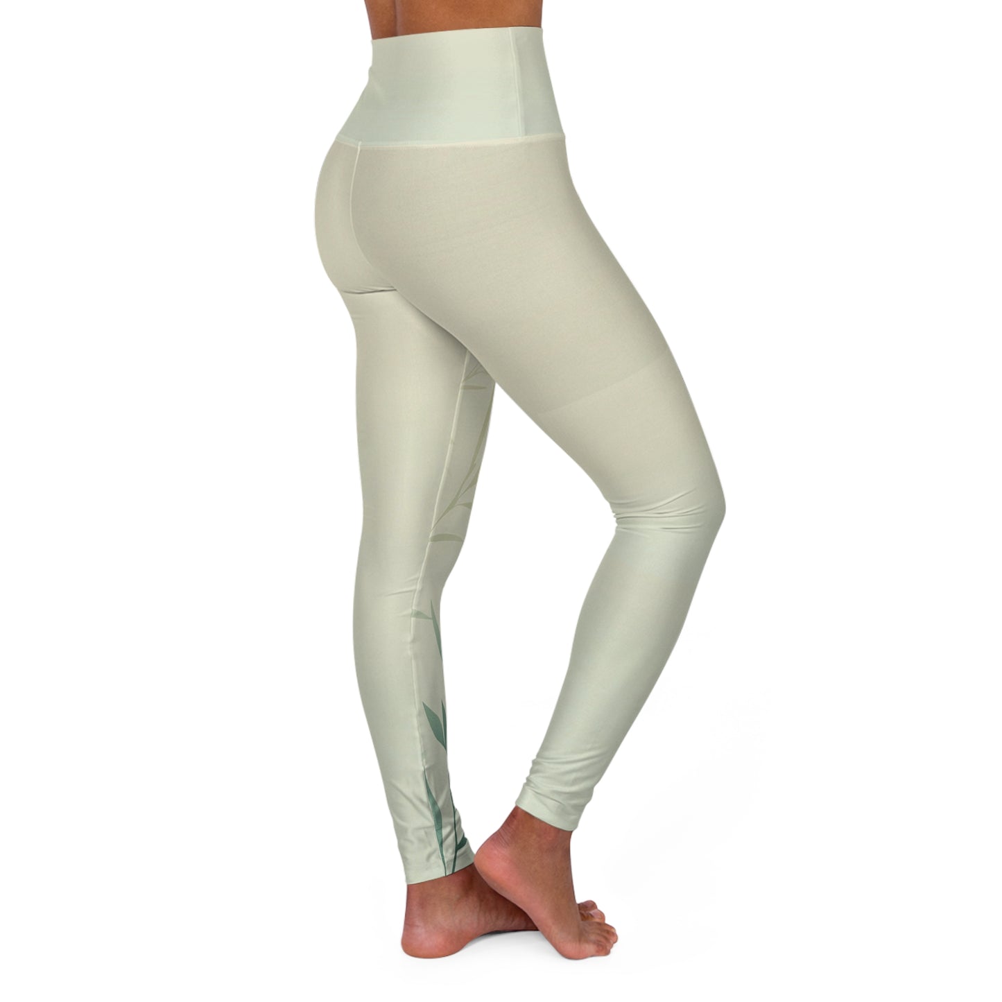 Angled side view of high-waisted leggings in light green, emphasizing the soft material and subtle design.