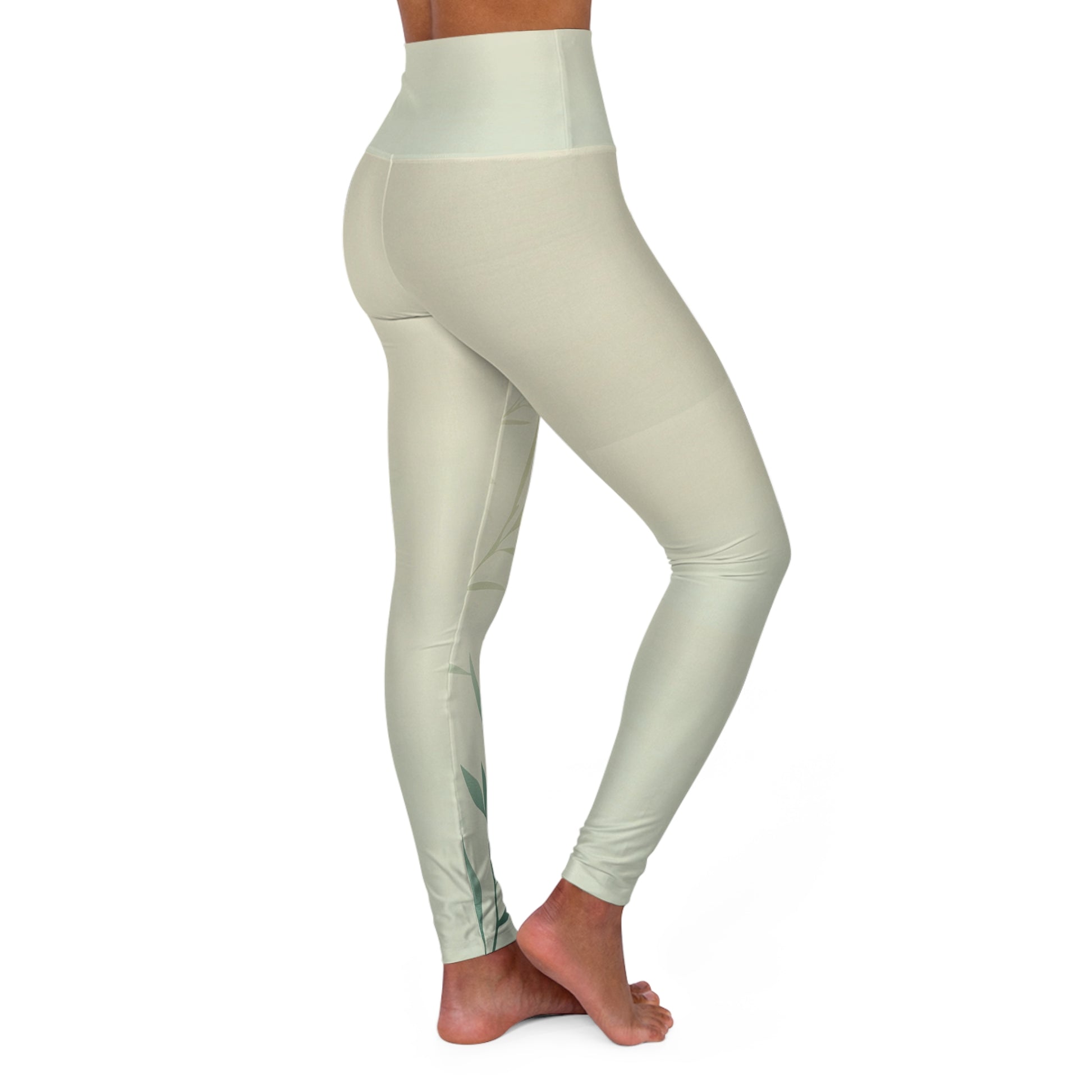Angled side view of high-waisted leggings in light green, emphasizing the soft material and subtle design.
