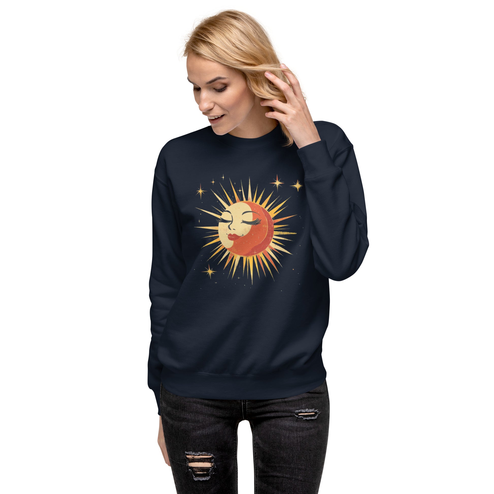 Woman wearing a navy sweatshirt featuring a bright vintage sun and moon design surrounded by stars.