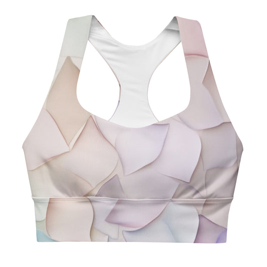 A front view of a longline sports bra with a soft pastel petal design, featuring a racerback cut and wide supportive band