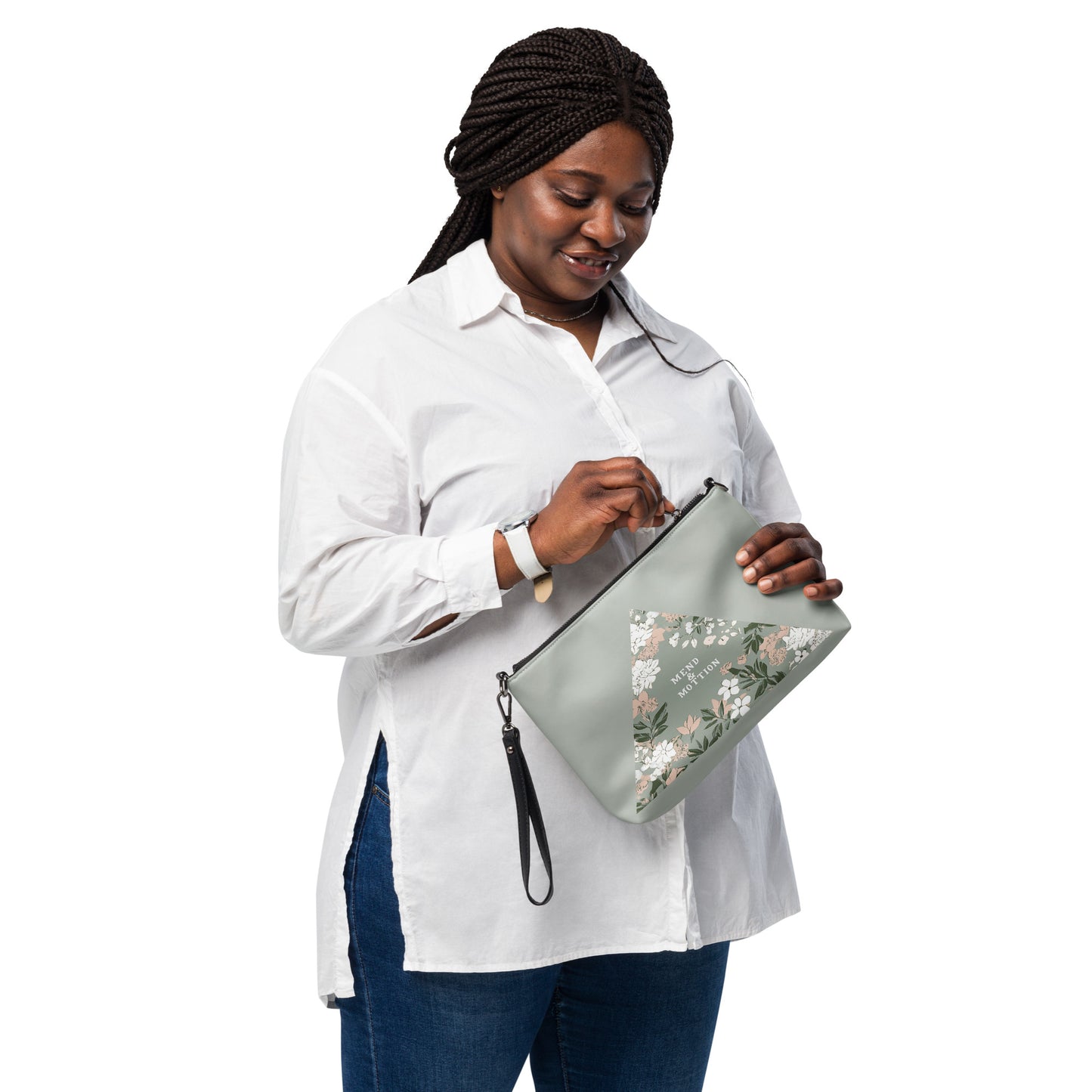 Woman holding a sage green crossbody bag with a floral triangle design, perfect for everyday use