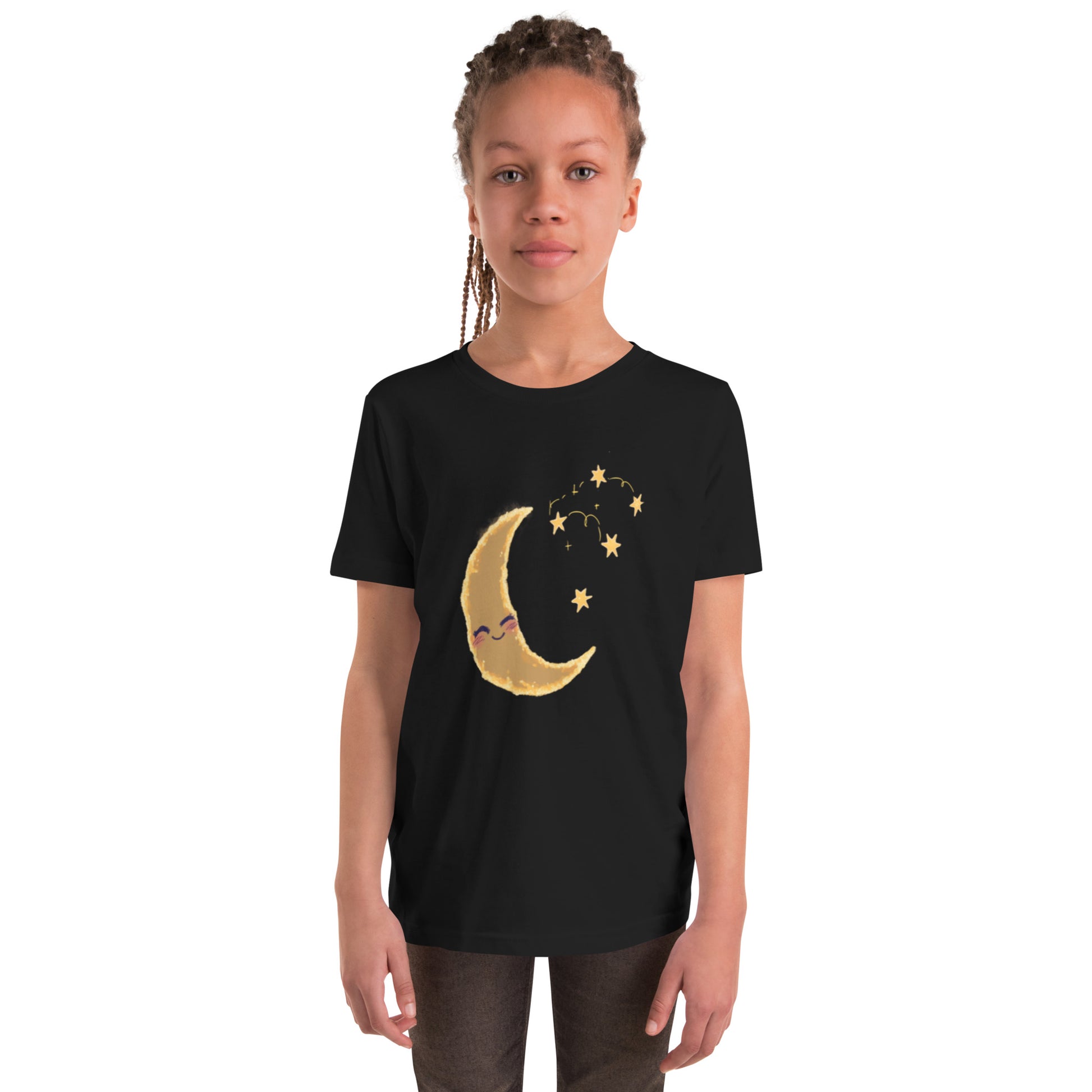 Youth black tee with a cheerful golden crescent moon and sparkling stars worn by a smiling child.