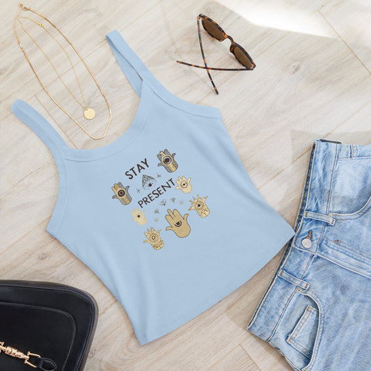 Baby blue crop tank top with "Stay Present" design, surrounded by celestial and Hamsa patterns, styled with accessories on a wooden surface